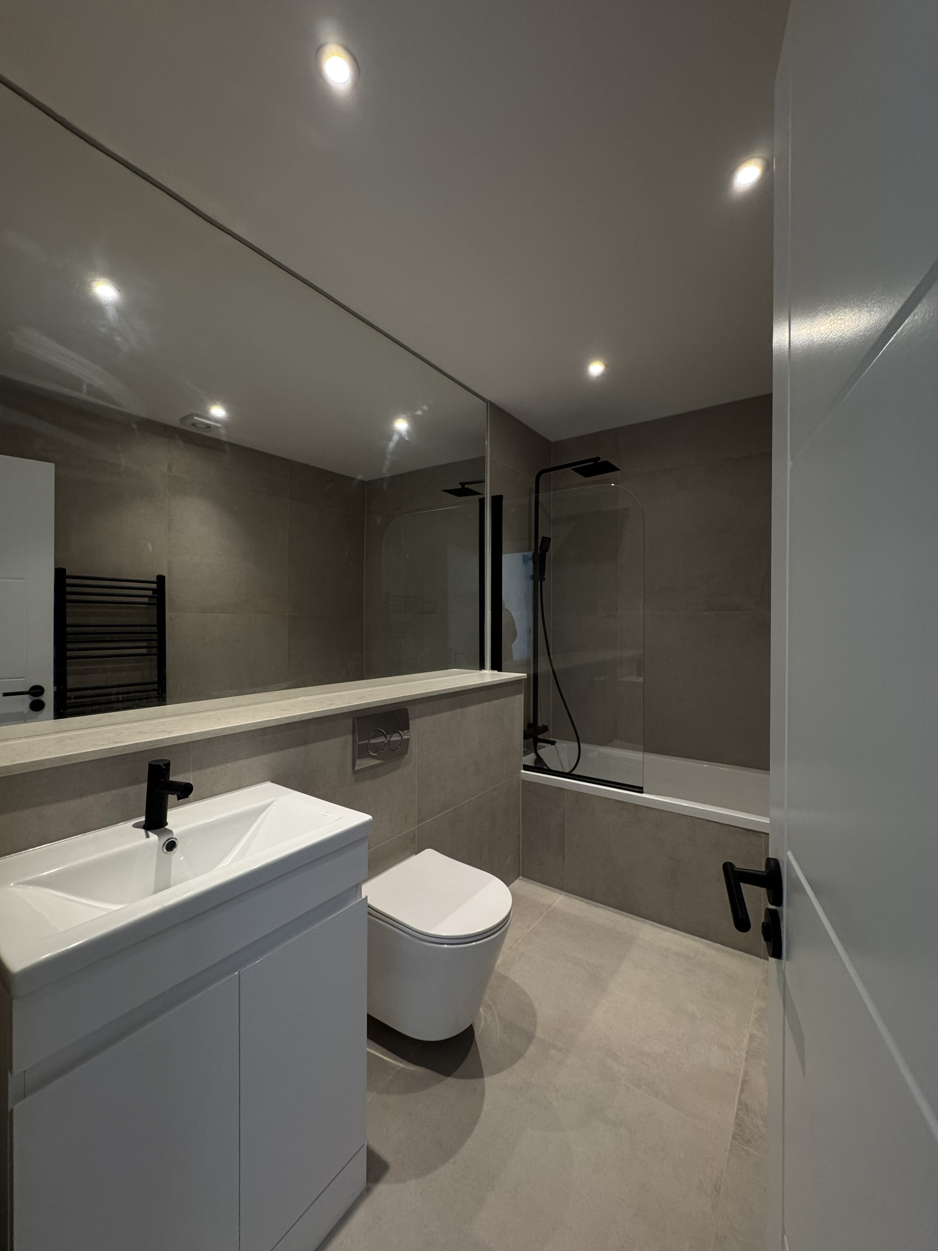 Bathroom dark tiling black fittings